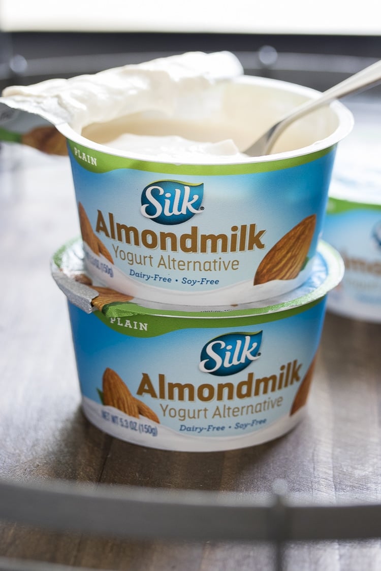 Two silk almond milk yogurt pots stacked on top of each other