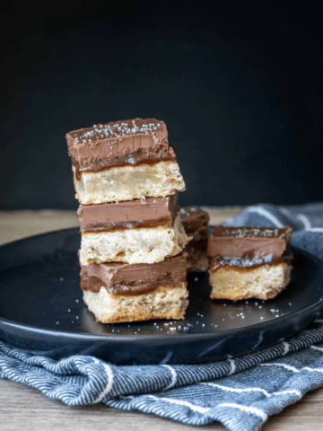 Squares of millionaire shortbread stacked on one another.